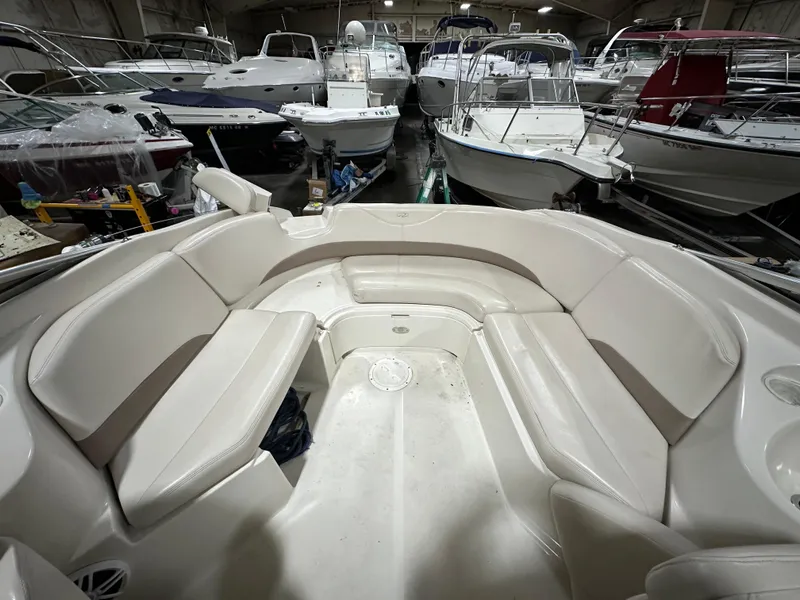Slide: The Image of 2001 Regal 2350 LSC boat interior with white seating in a storage facility. - 6