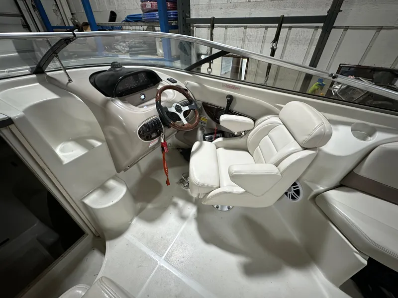 Slide: The Image of Interior of a 2001 Regal 2350 LSC boat with steering wheel and seating. - 8