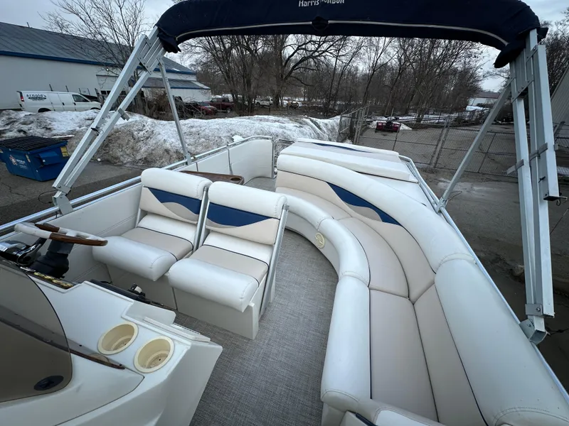 Slide: The Image of 2003 Harris FloteBote 260 Royal Heritage pontoon boat with white seating and blue accents. - 13