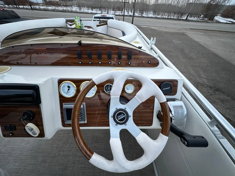 Slide: The Image of Steering wheel and dashboard of 2003 Harris FloteBote 260 Royal Heritage boat. - 15