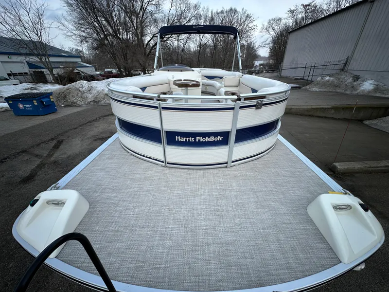 Slide: The Image of 2003 Harris FloteBote 260 Royal Heritage pontoon boat on trailer, parked outdoors. - 5
