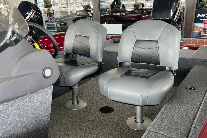 Slide: The Image of 2022 Tracker Super Guide V 16 SC boat interior with two gray seats. - 13