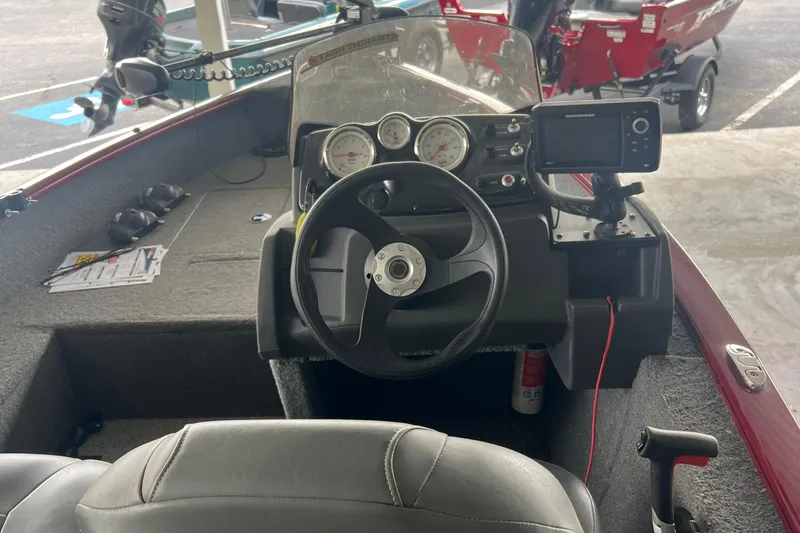 Slide: The Image of 2022 Tracker Super Guide V 16 SC boat interior with steering wheel and dashboard controls. - 15