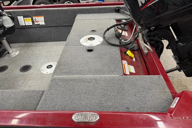 Slide: The Image of 2022 Tracker Super Guide V 16 SC boat interior with motor and seating area. - 2