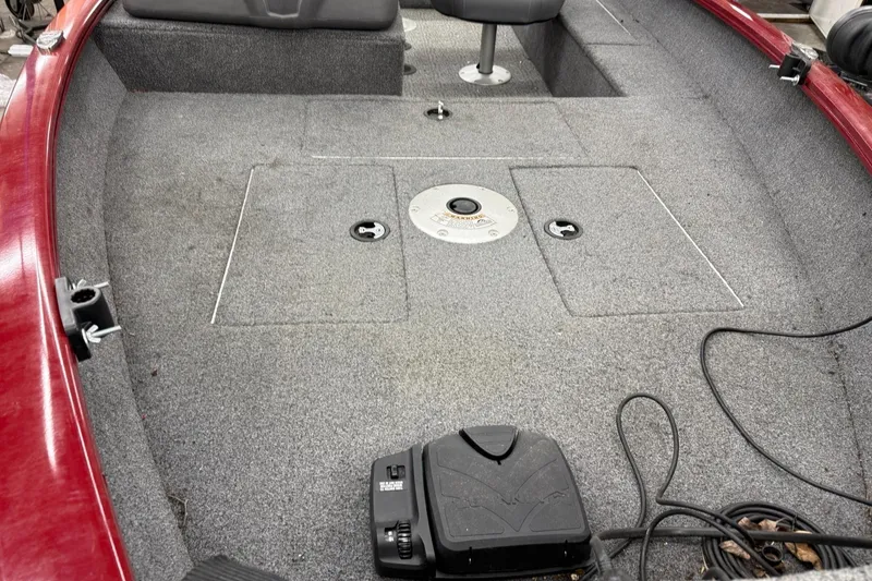 Slide: The Image of 2022 Tracker Super Guide V 16 SC boat interior with gray carpet and seating. - 4