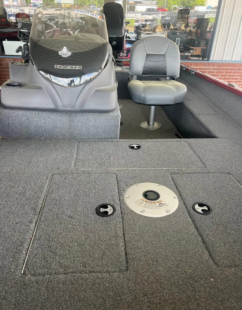 Slide: The Image of 2022 Tracker Super Guide V 16 SC boat interior with seating and control panel. - 9