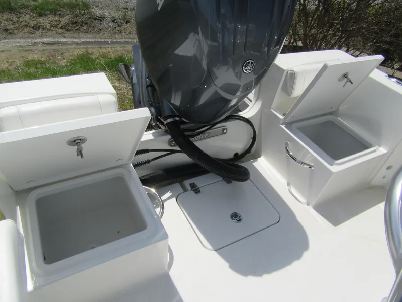 Slide: The Image of 2025 Parker 18SE Center Console boat with open storage compartments and engine view. - 11