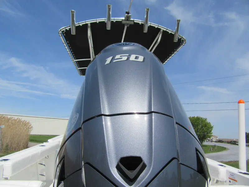 Slide: The Image of 2025 Parker 18SE Center Console boat with a 150 horsepower engine, under a clear blue sky. - 13