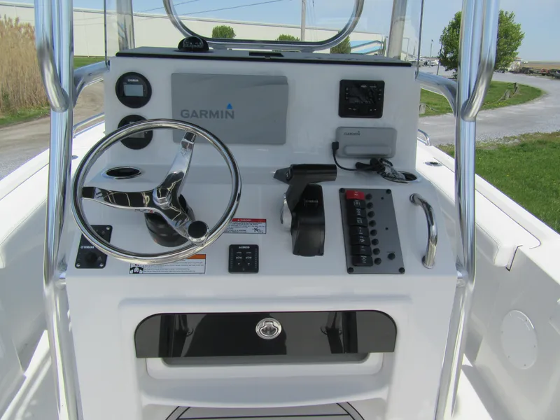 Slide: The Image of 2025 Parker 18SE Center Console boat dashboard with Garmin navigation system and steering wheel. - 2