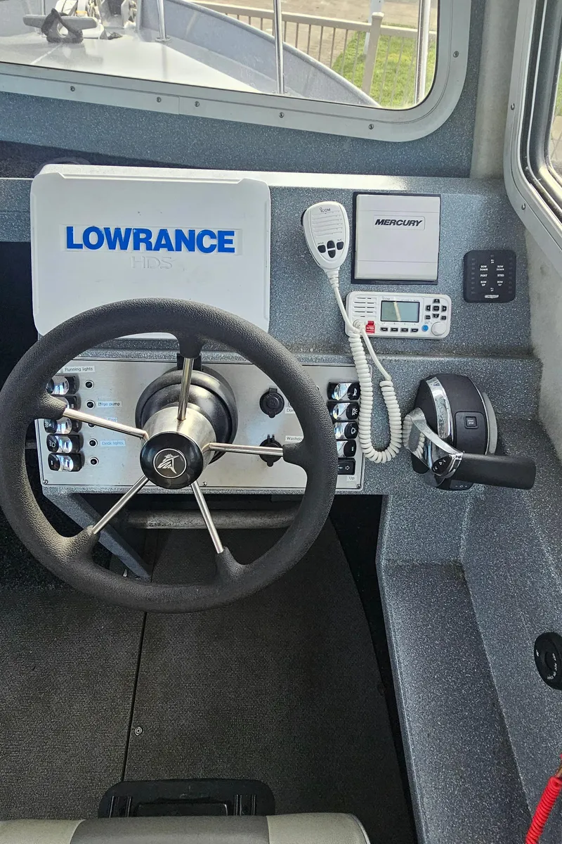 Slide: The Image of 2018 KingFisher 2325 Coastal Express dashboard with Lowrance navigation system and controls. - 14