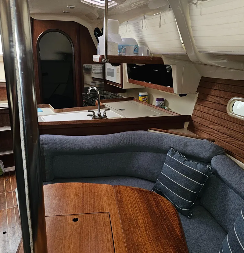 Slide: The Image of Interior of 1995 Hunter 336 sailboat with cozy seating and kitchen area. - 11