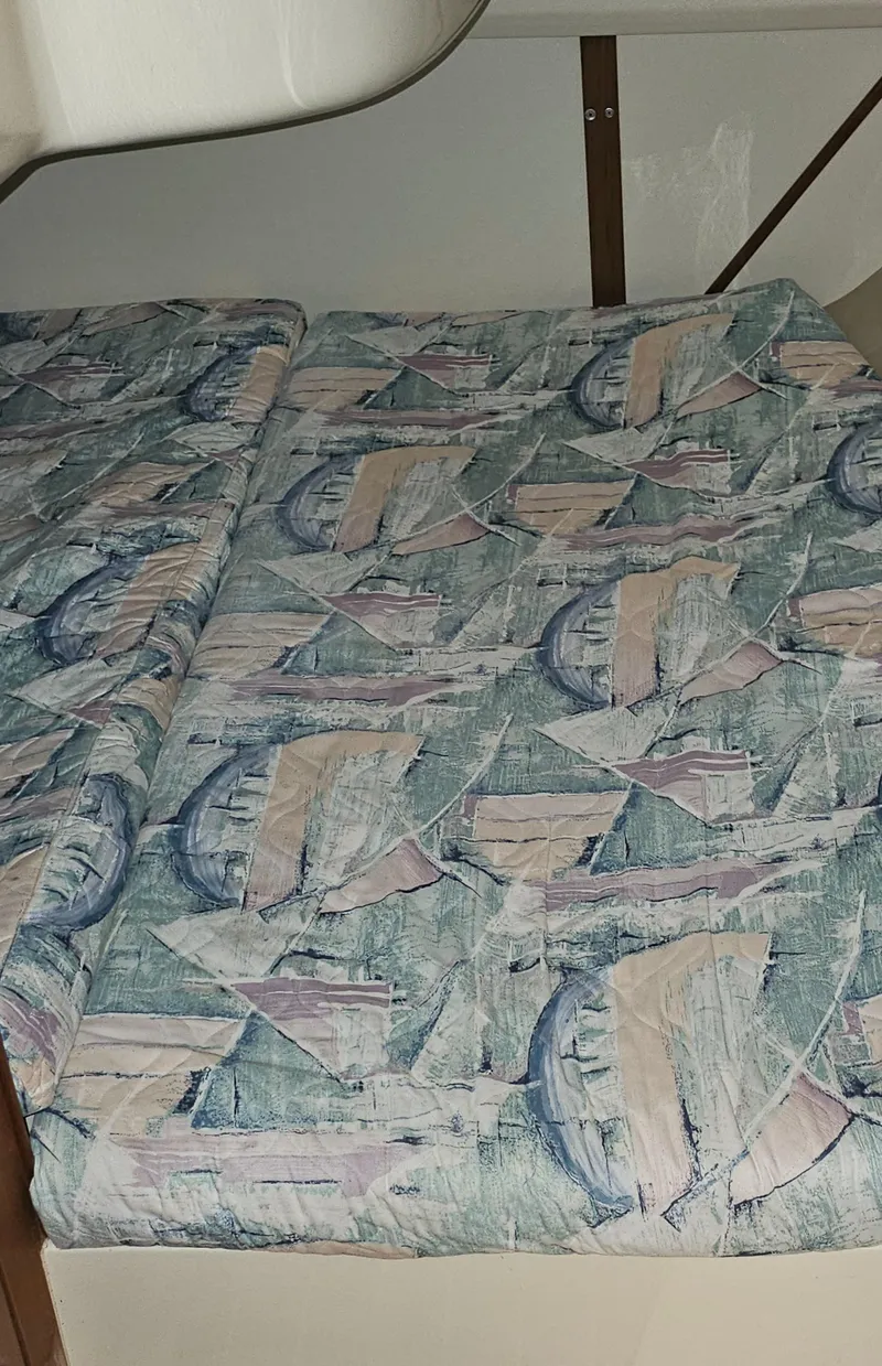 Slide: The Image of Patterned fabric upholstery in a 1995 Hunter 336 boat interior. - 15