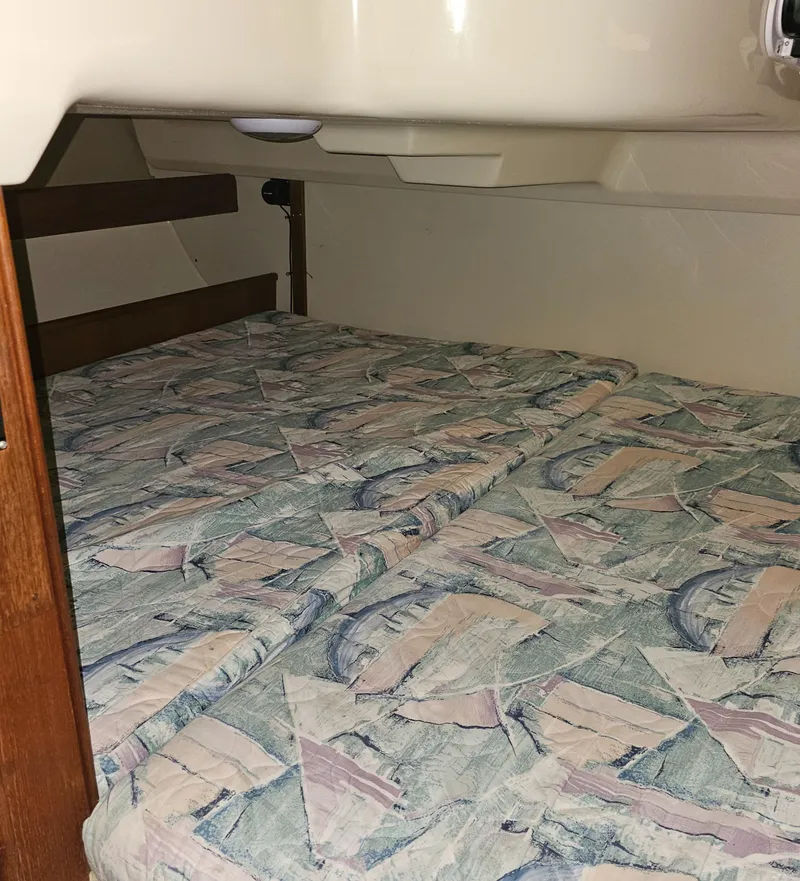 Slide: The Image of Cozy cabin bed in 1995 Hunter 336 sailboat with patterned bedding. - 16