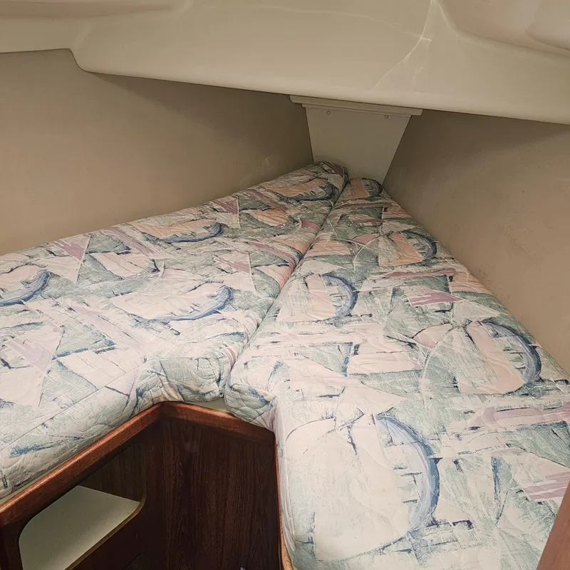 Slide: The Image of Interior cabin of a 1995 Hunter 336 sailboat with patterned bedding. - 17