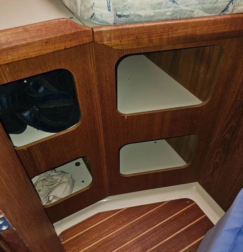 Slide: The Image of Wooden cabinet with open shelves inside a 1995 Hunter 336 sailboat. - 18