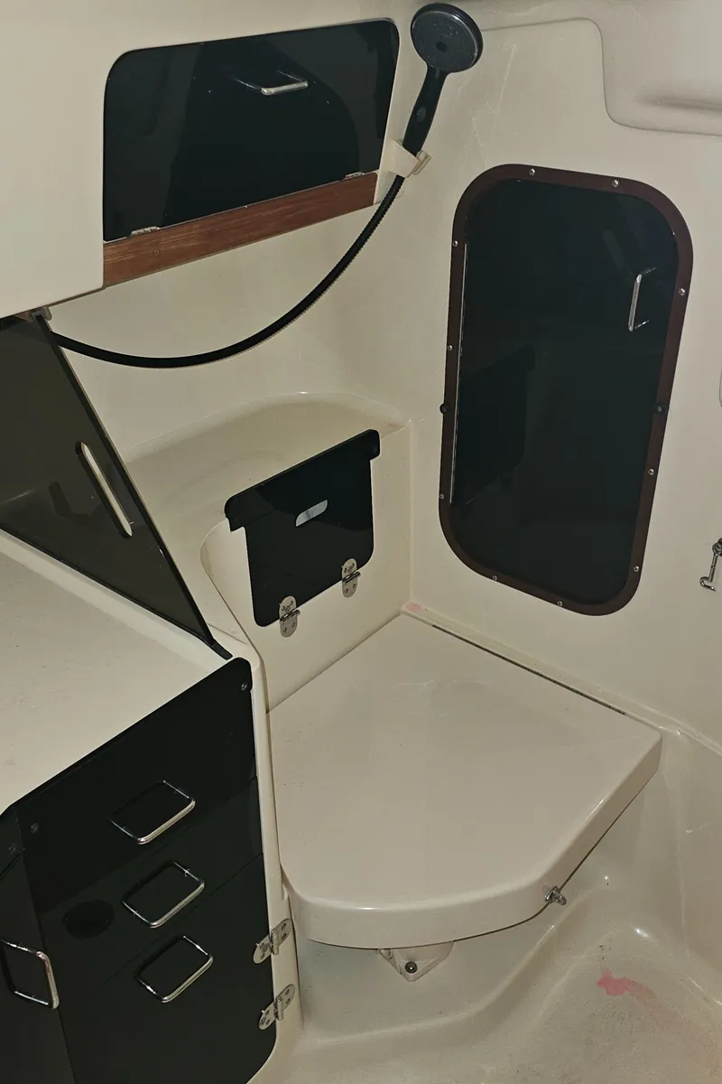 Slide: The Image of 1995 Hunter 336 sailboat interior with compact bathroom and storage. - 20