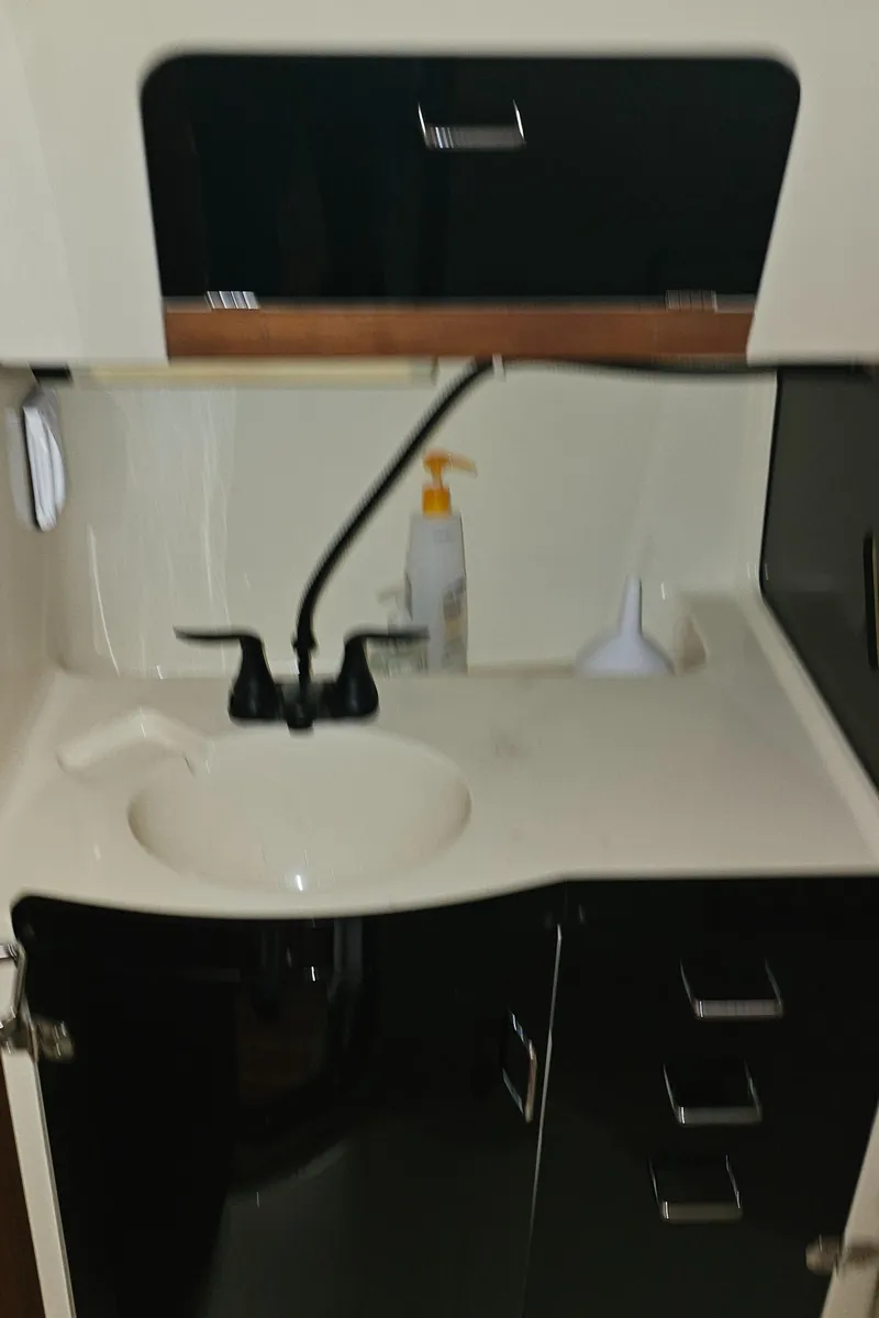 Slide: The Image of Compact bathroom sink area in a 1995 Hunter 336 sailboat. - 21