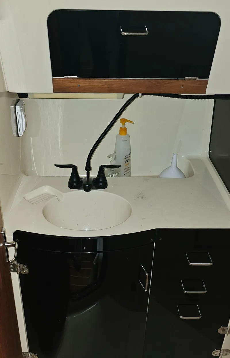 Slide: The Image of Compact sink area in a 1995 Hunter 336 boat interior. - 22