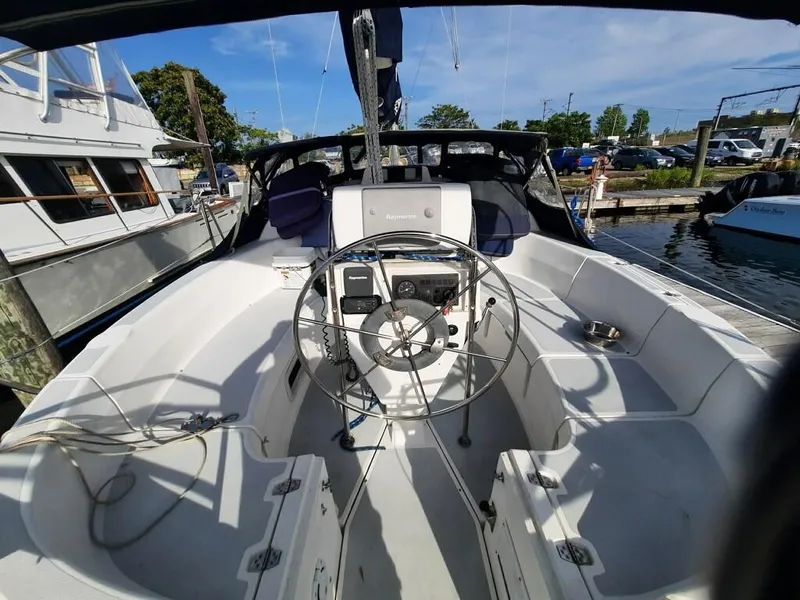 Slide: The Image of Cockpit of a 1995 Hunter 336 sailboat docked at a marina. - 4
