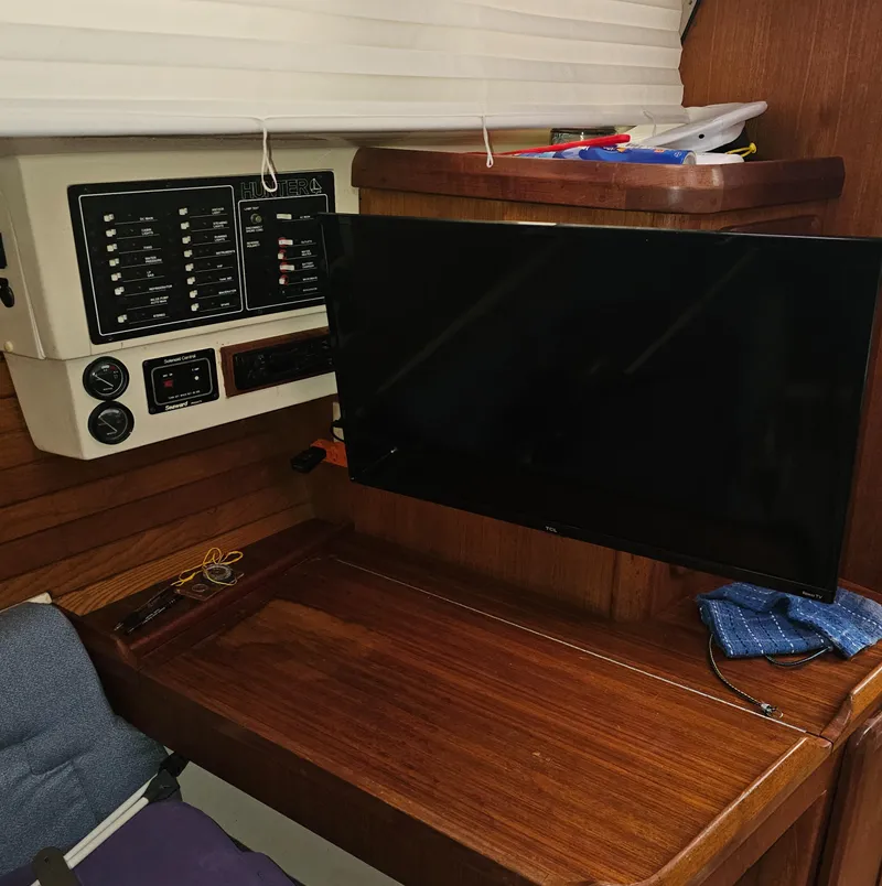 Slide: The Image of 1995 Hunter 336 yacht interior with control panel and mounted TV. - 8