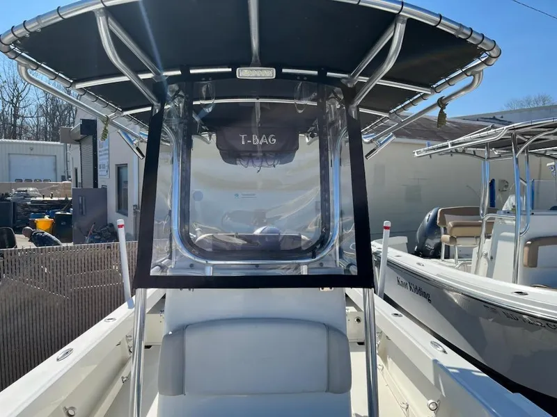 Slide: The Image of Parker 2100 Special Edition 2016 boat with T-top and clear windshield in a marina setting. - 3