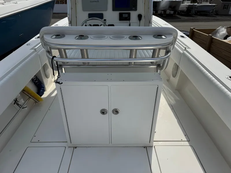 Slide: The Image of 2010 Contender 25 Open boat interior with rod holders and storage cabinet. - 10