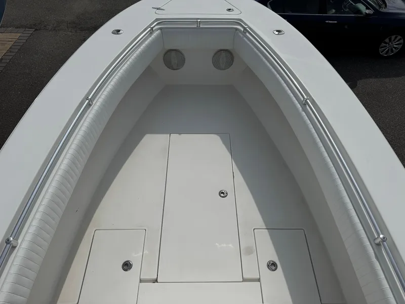 Slide: The Image of 2010 Contender 25 Open boat deck, spacious and well-maintained, with storage compartments. - 5
