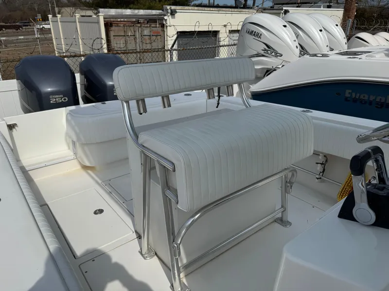 Slide: The Image of 2010 Contender 25 Open boat with dual Yamaha engines and white seating. - 8