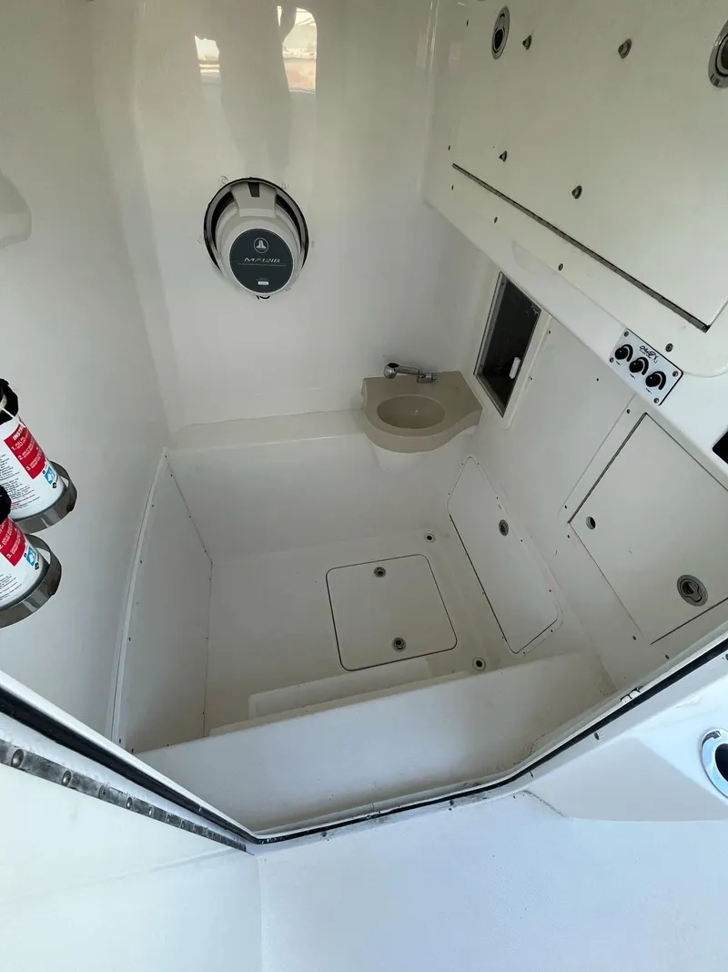 Slide: The Image of 2021 Invincible 39 Open Fisherman boat interior with storage and compact toilet. - 10