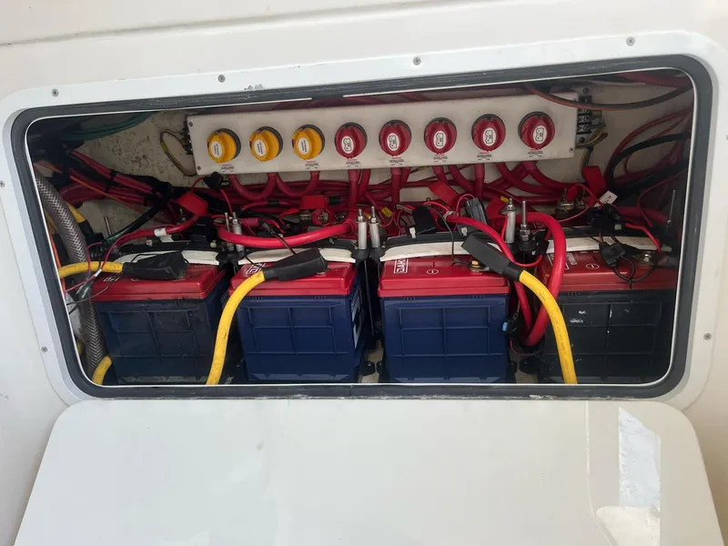 Slide: The Image of Battery compartment of a 2021 Invincible 39 Open Fisherman, featuring multiple batteries and wiring. - 11