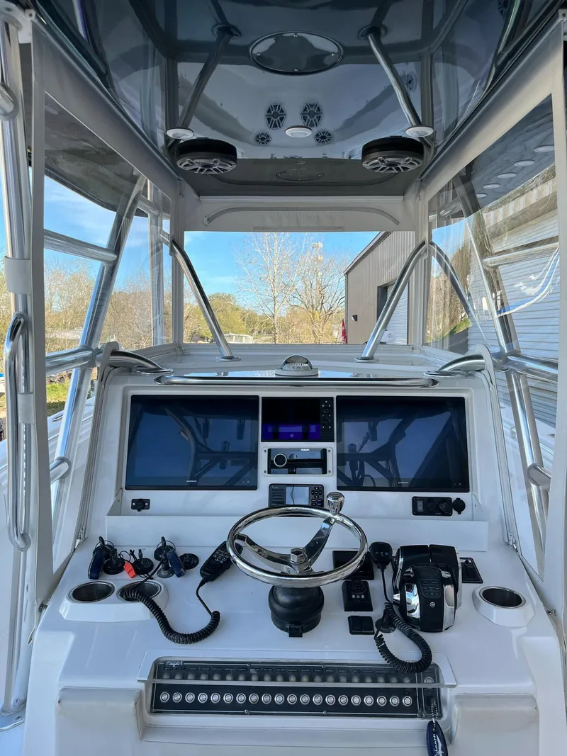 Slide: The Image of 2021 Invincible 39 Open Fisherman boat cockpit with advanced navigation equipment. - 15