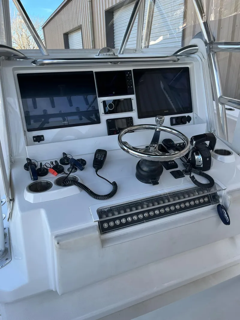 Slide: The Image of 2021 Invincible 39 Open Fisherman boat console with advanced navigation and control systems. - 16