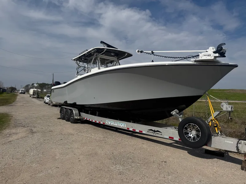 Slide: The Image of 2021 Invincible 39 Open Fisherman boat on trailer, parked outdoors. - 2