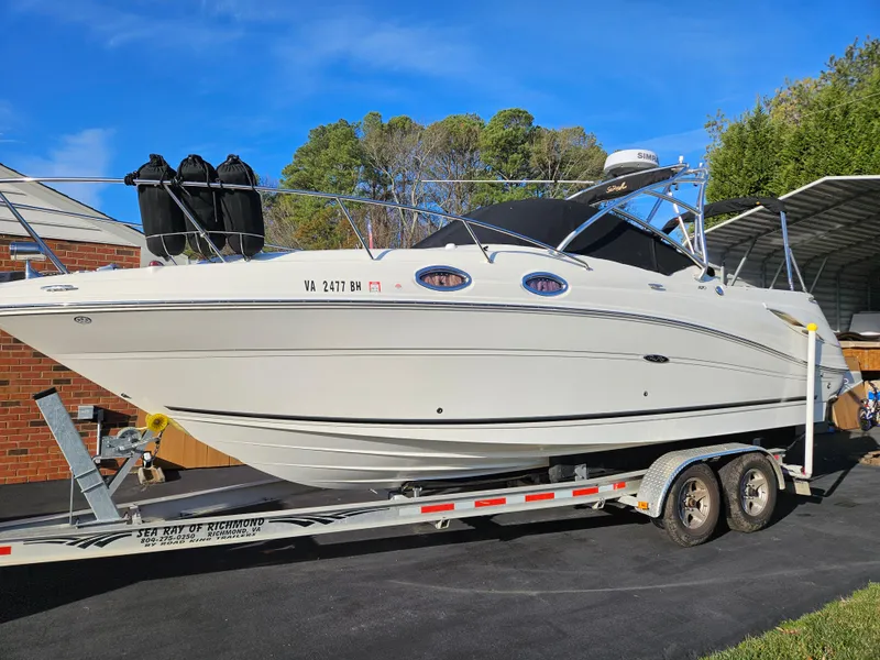The Image of 2006 Sea Ray 270 Amberjack boat on trailer, parked outdoors. - 0