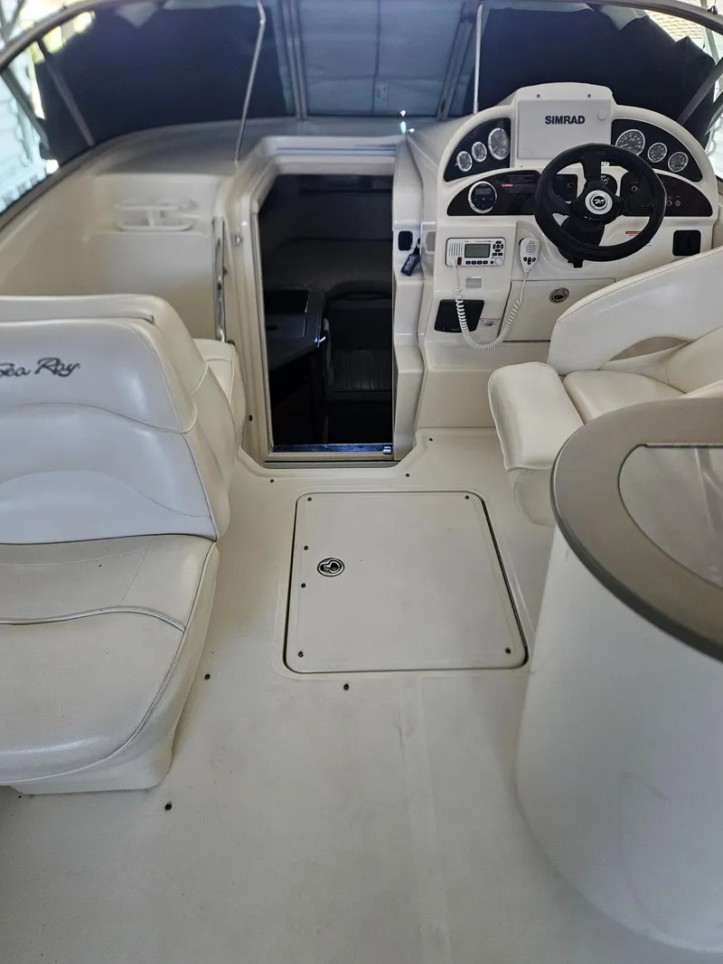 Slide: The Image of 2006 Sea Ray 270 Amberjack boat interior with helm and seating area. - 10