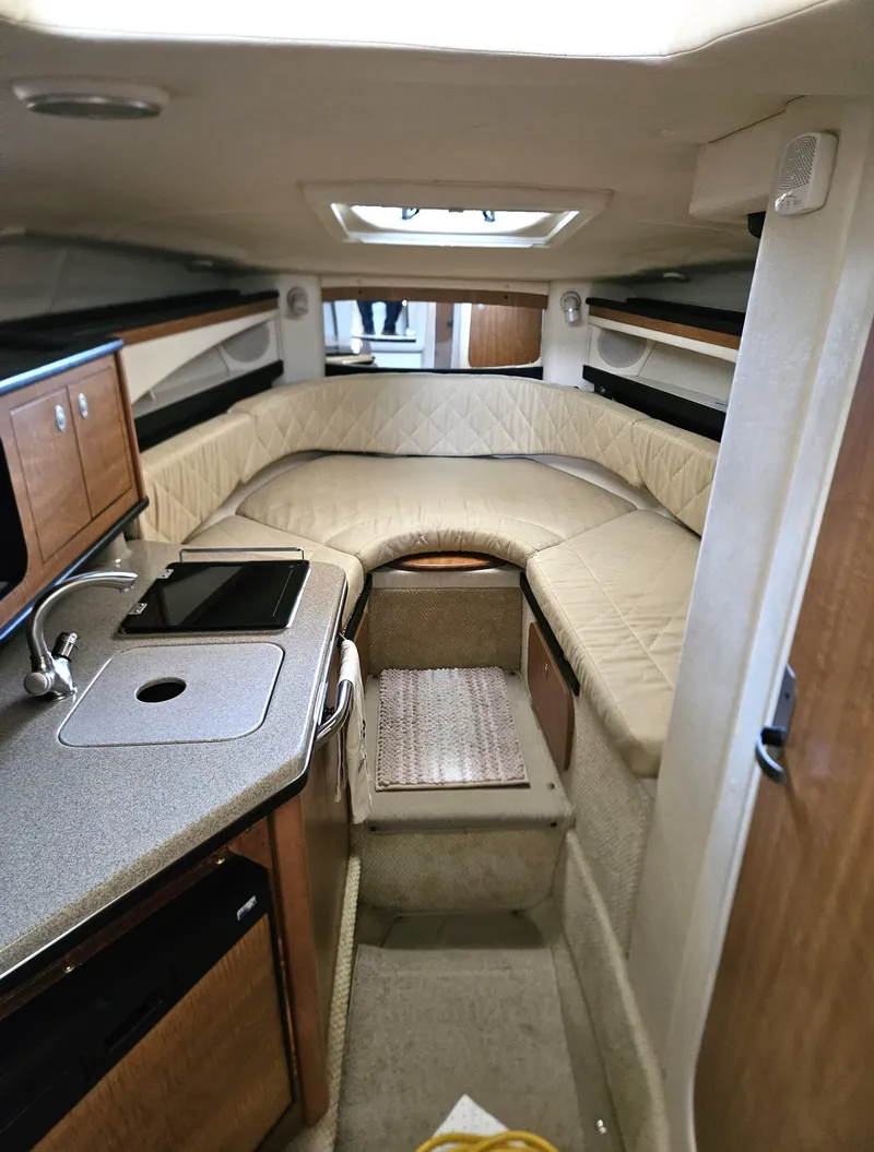 Slide: The Image of Interior of 2006 Sea Ray 270 Amberjack boat with kitchenette and seating area. - 11