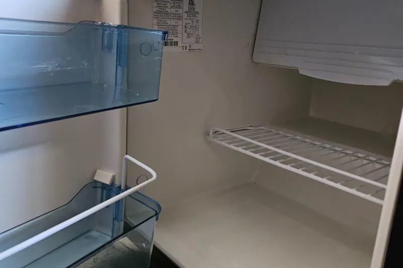 Slide: The Image of Empty refrigerator interior on a 2006 Sea Ray 270 Amberjack boat. - 16