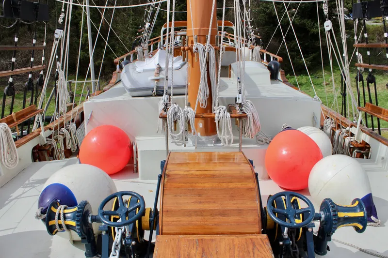 Slide: The Image of Deck view of 1988 Custom Lahaina Welding Co. Square Topsail Ketch with colorful buoys and rigging. - 19