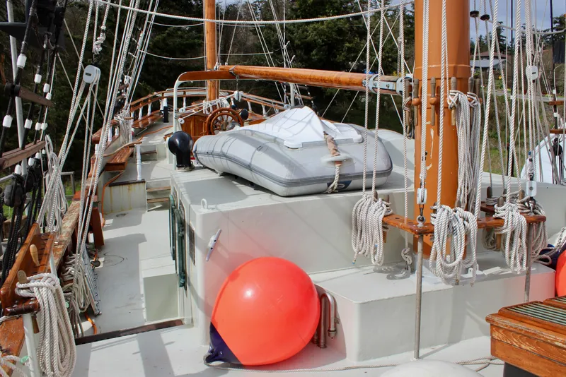 Slide: The Image of Deck of 1988 Custom Lahaina Welding Co. Square Topsail Ketch with ropes and lifeboat. - 22
