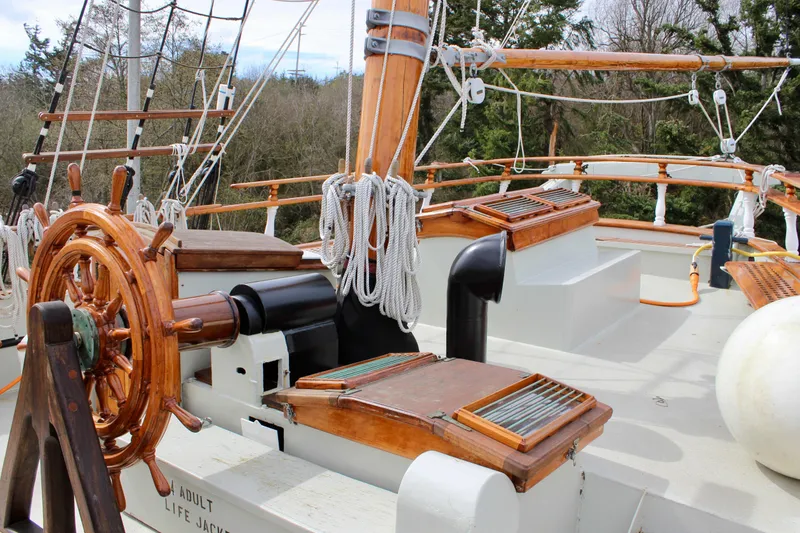Slide: The Image of Wooden helm and rigging on 1988 Lahaina Welding Co. Square Topsail Ketch deck. - 28