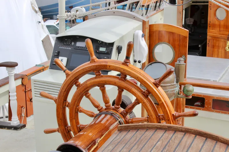 Slide: The Image of Wooden helm of 1988 Custom Lahaina Welding Co. Square Topsail Ketch, showcasing nautical craftsmanship. - 31