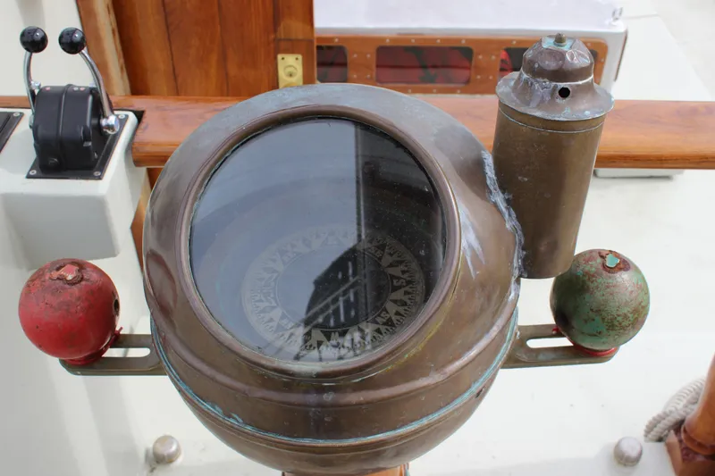 Slide: The Image of Vintage compass on 1988 Lahaina Welding Co. Square Topsail Ketch, featuring nautical design elements. - 33