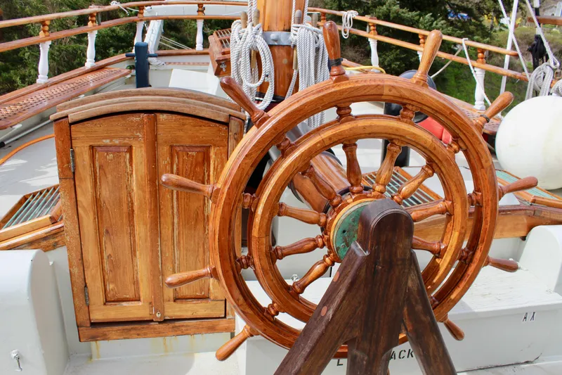 Slide: The Image of Wooden ship wheel on 1988 Lahaina Welding Co. Square Topsail Ketch, showcasing nautical craftsmanship. - 38