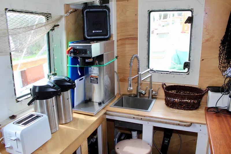 Slide: The Image of Compact kitchen area on a 1988 Custom Lahaina Welding Co. Square Topsail Ketch with appliances and sink. - 44