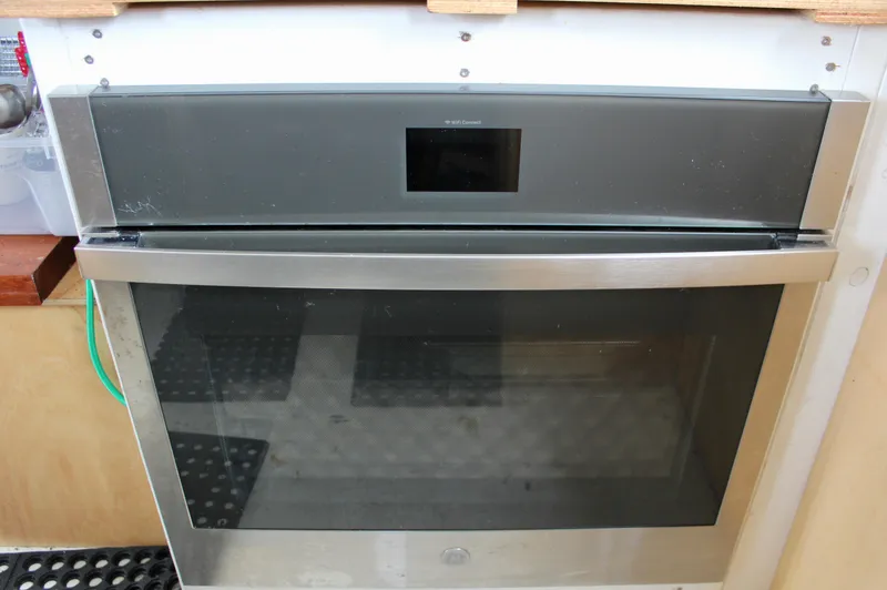 Slide: The Image of Modern built-in oven with digital display in a kitchen setting. - 47