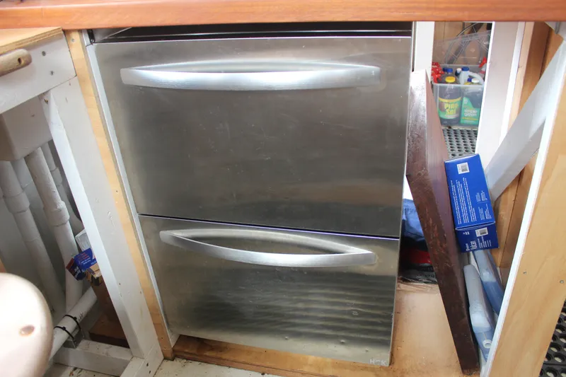 Slide: The Image of Stainless steel drawers in a wooden cabinet on a 1988 Lahaina Welding Co. Square Topsail Ketch. - 49