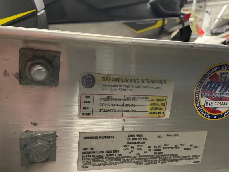 Slide: The Image of Tire and loading information label on a 2011 Regal 2750 Cuddy boat. - 18