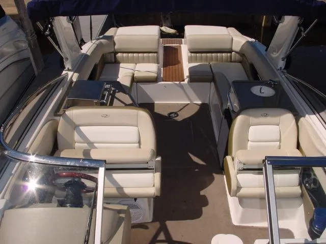 Slide: The Image of 2011 Regal 2750 Cuddy boat interior with beige seating and spacious layout. - 7