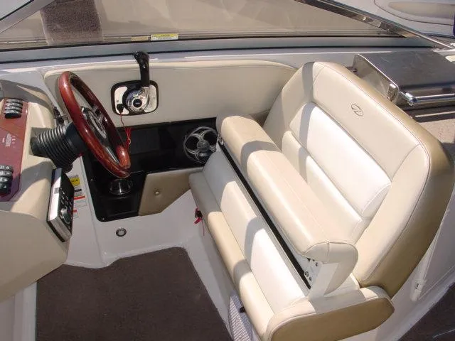 Slide: The Image of Interior of 2011 Regal 2750 Cuddy boat with steering wheel and seating. - 8