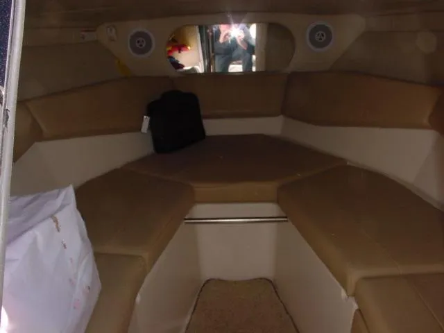 Slide: The Image of 2011 Regal 2750 Cuddy cabin interior with beige seating and compact design. - 9